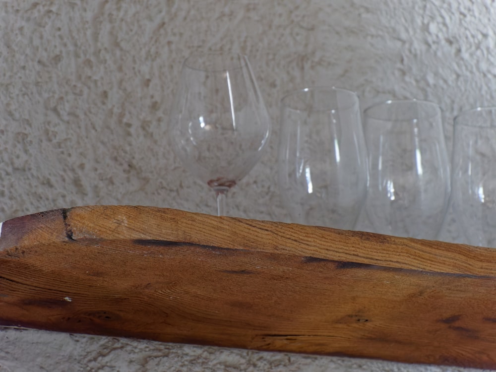 a wooden shelf with wine glasses on it