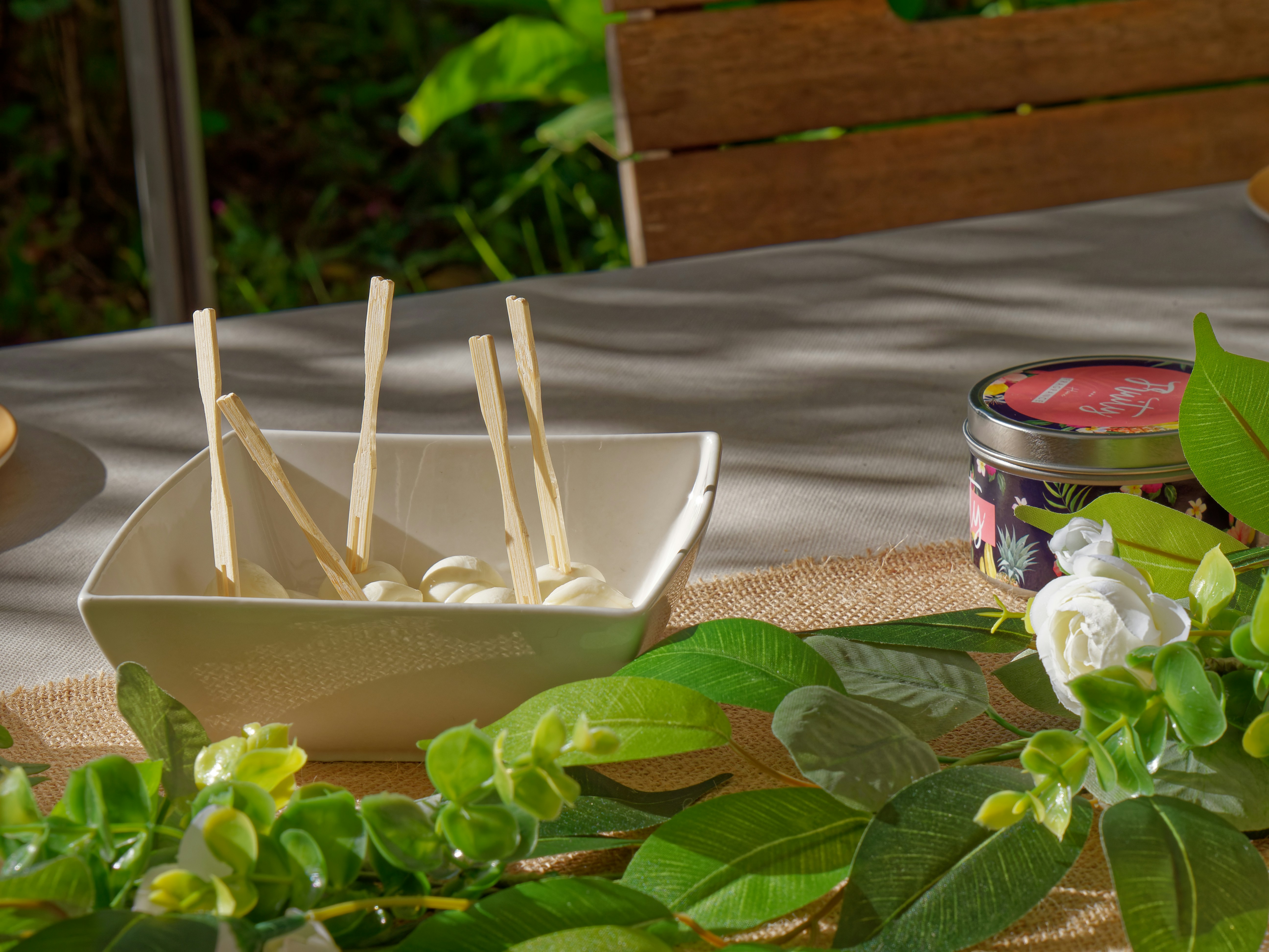 Eco-friendly ice cream party supplies including cups and wooden cutlery