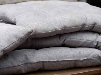 Neatly stacked premium bath mats and cushion covers ready for international shipment.
