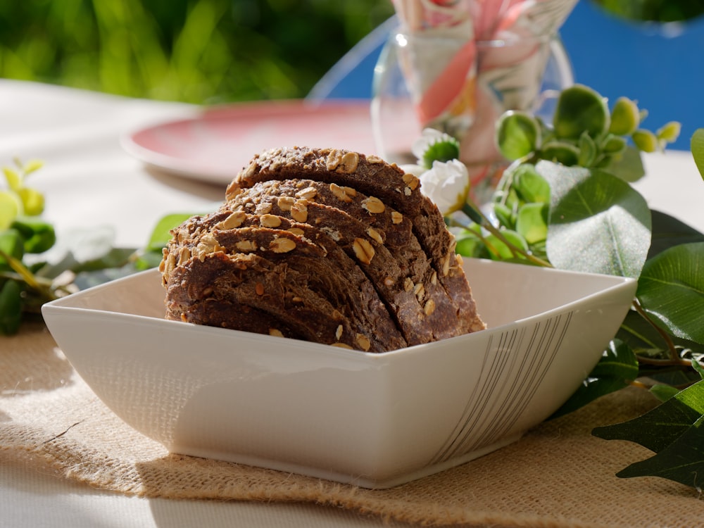 a white bowl filled with sliced brownies on top of a table