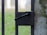 Close-up of a freshly repaired metal gate with a smooth black finish.