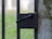 Close-up of a freshly repaired metal gate with a smooth black finish.
