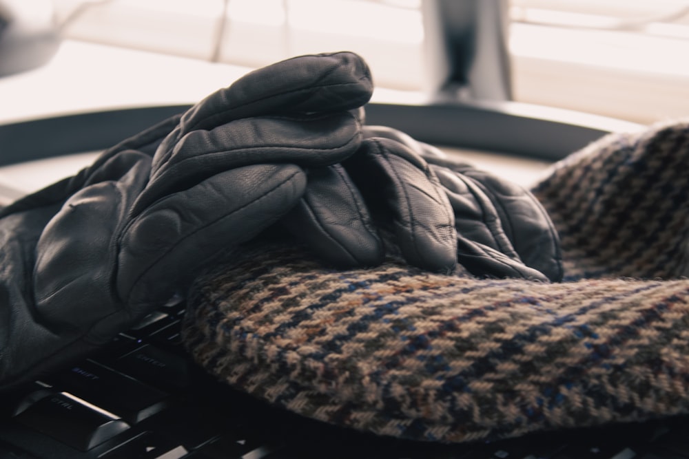 a pair of gloves sitting on top of a keyboard