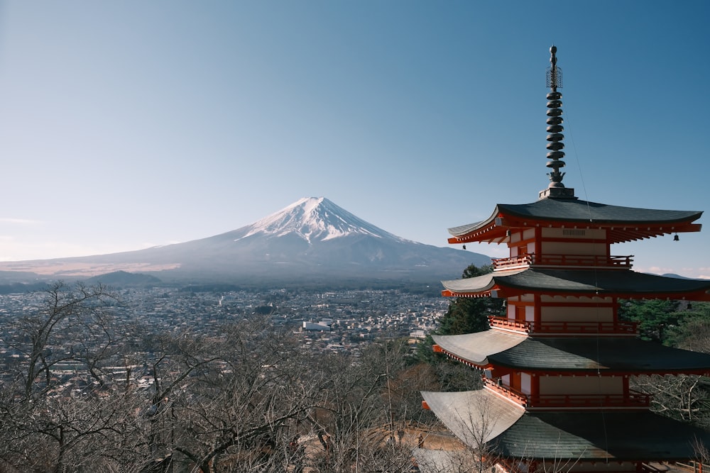 a tall pagoda with a mountain in the background