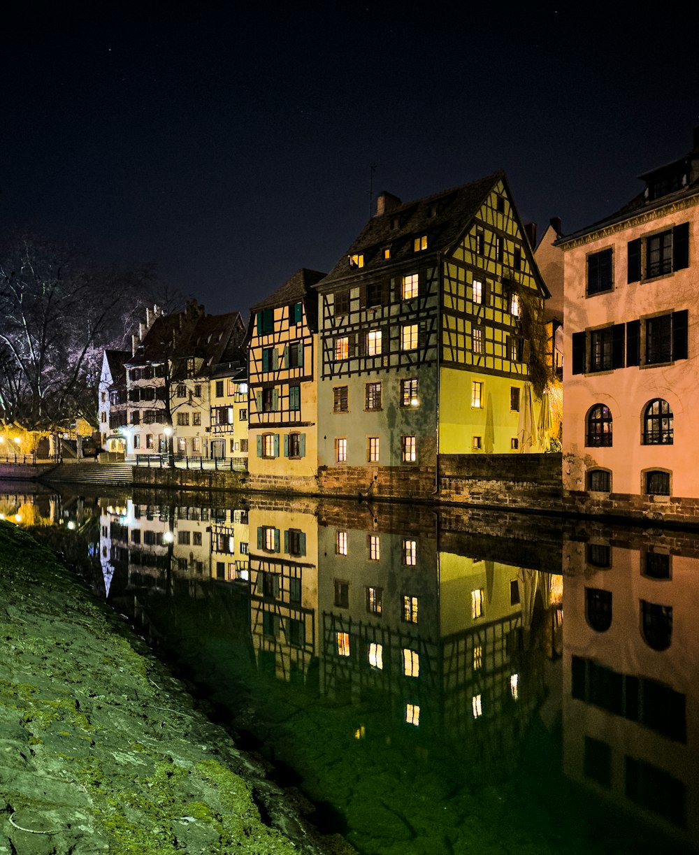 a row of buildings next to a body of water