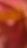 A blurred image with a mix of warm colors such as pink, orange, and red, creating an abstract appearance.