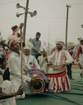 A group of teachers and students participating in a cultural workshop with traditional instruments.