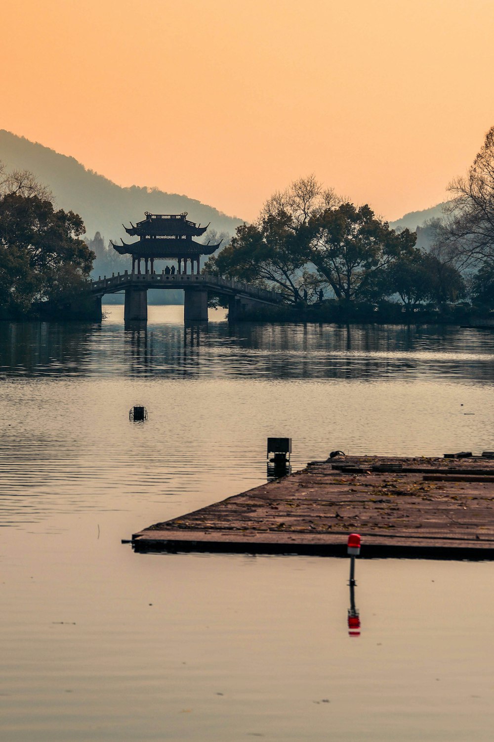 a large body of water with a bridge in the background