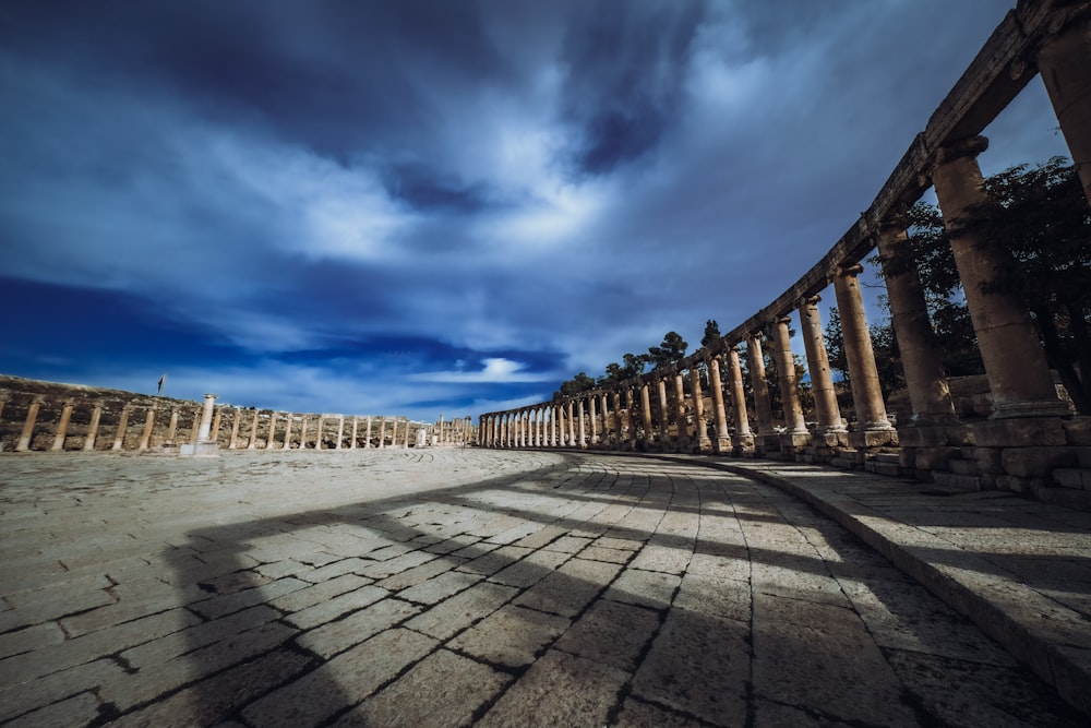 a long row of pillars sitting on top of a sandy beach