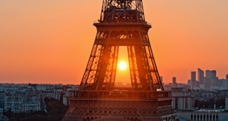 An inspiring image of the Eiffel Tower against a sunset backdrop.