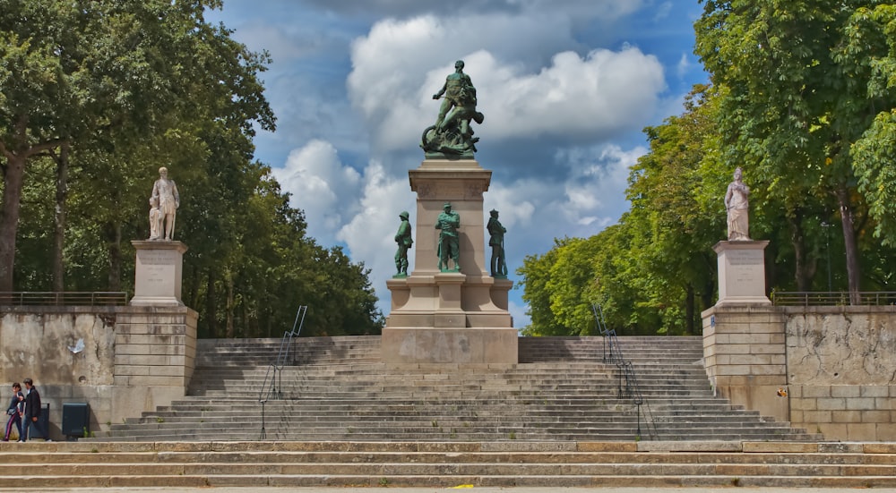 a statue of a man on a horse in a park