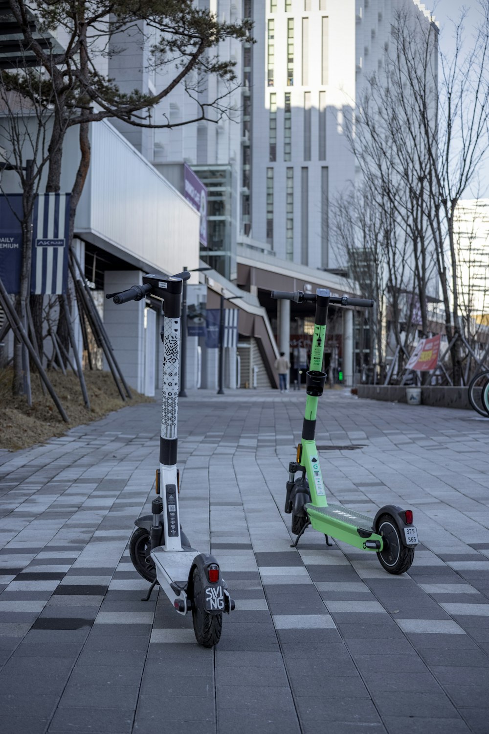 a green scooter is parked on the street