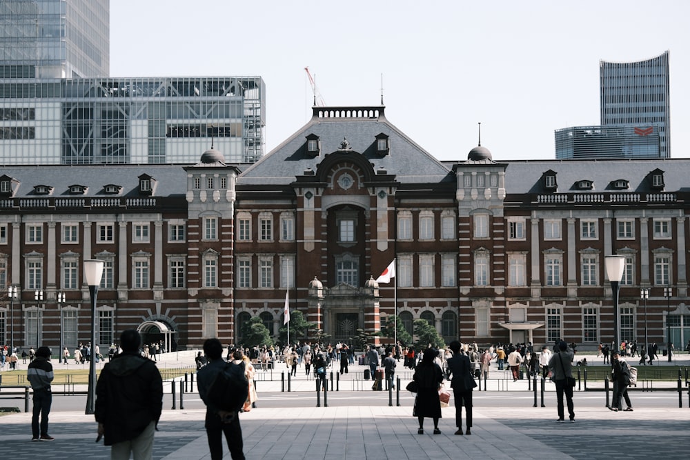 a group of people standing in front of a building