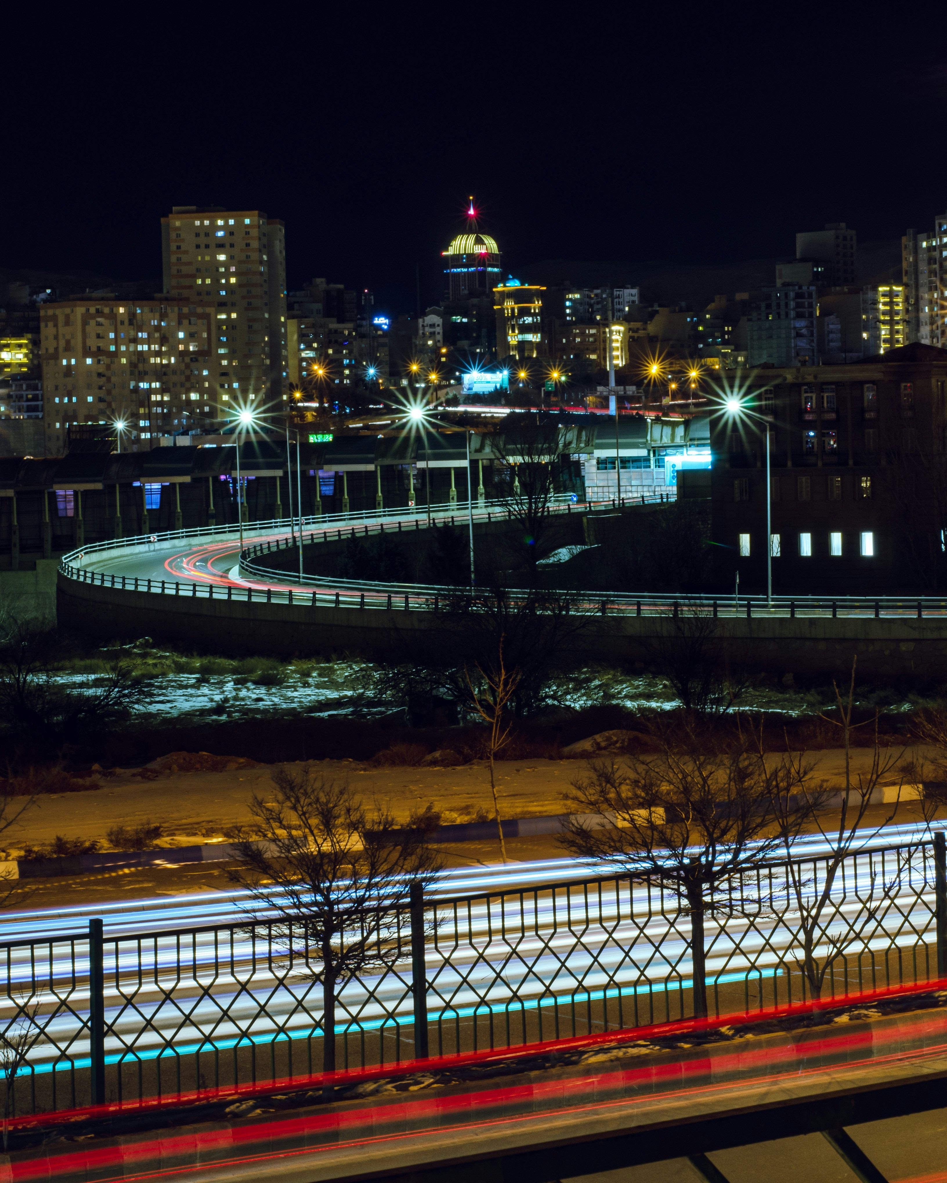 a view of a city at night from a bridge