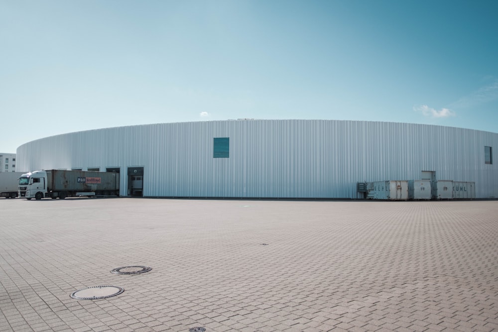 a large white building sitting on the side of a road