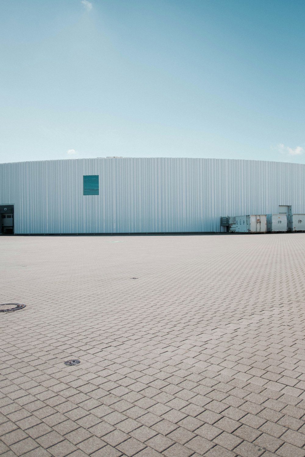 a large warehouse building with a blue sky in the background