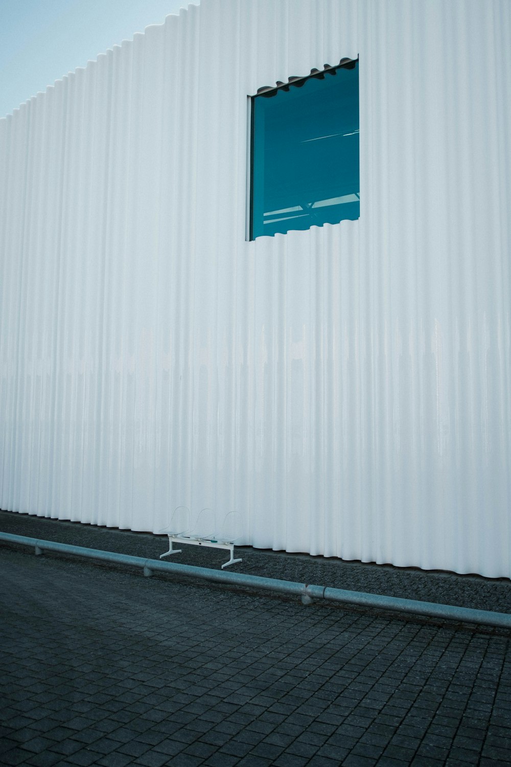 a white building with a blue window on the side of it