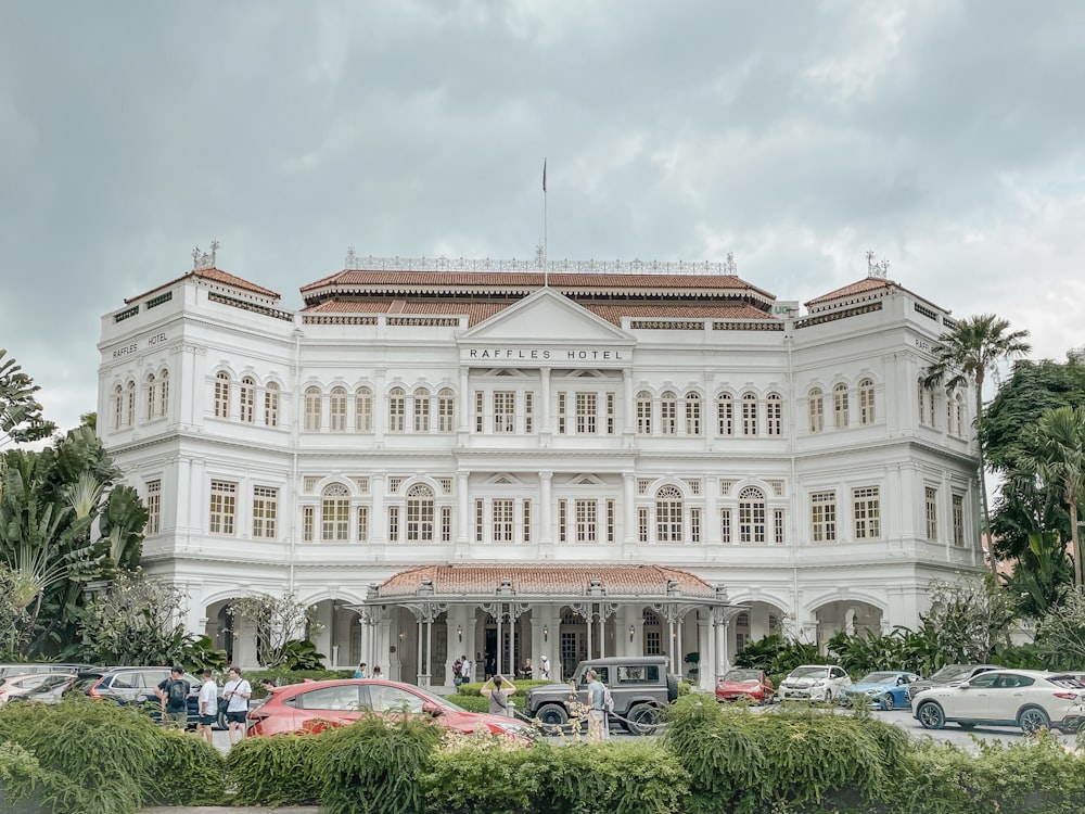 a large white building with cars parked in front of it