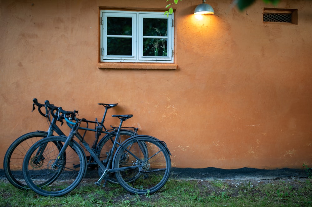 a couple of bikes parked next to a building