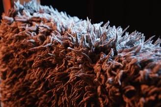 Close-up photo of mop yarn fibers showing texture and quality in bright factory lighting.