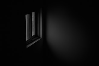 A dimly lit room symbolizing secrecy and silence.