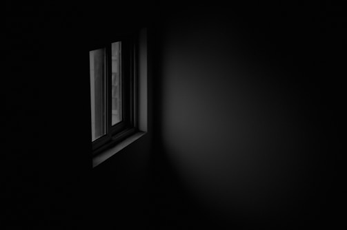 A dimly lit room symbolizing secrecy and silence.