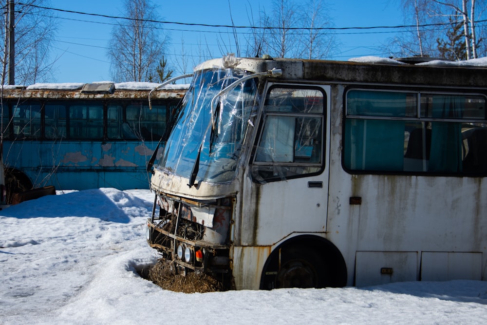 an old bus that is sitting in the snow