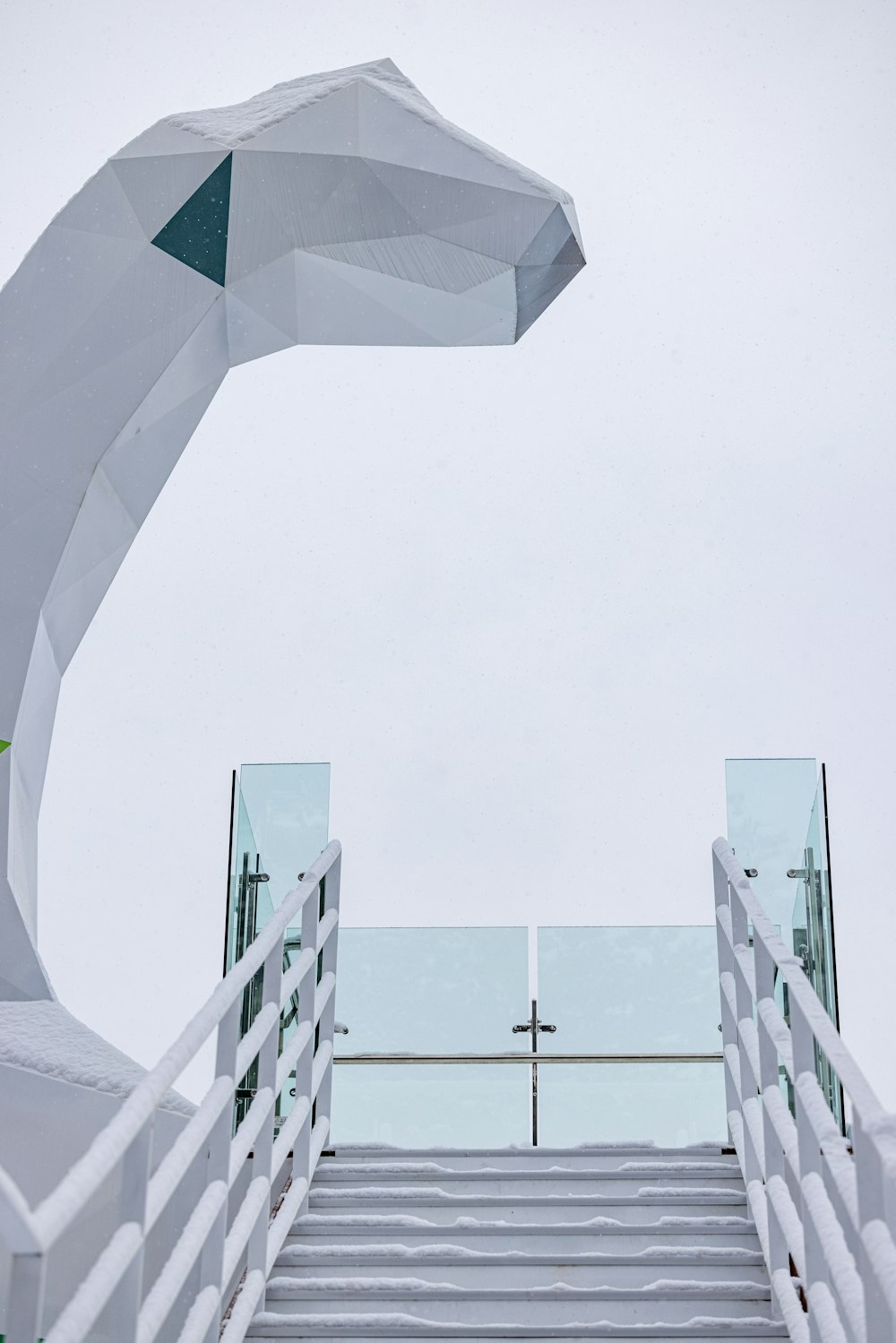 a white staircase leading up to a white sculpture