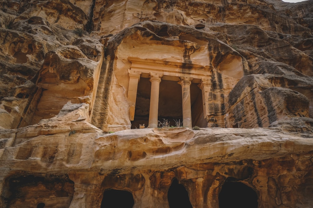 a group of people standing at the entrance to a cave