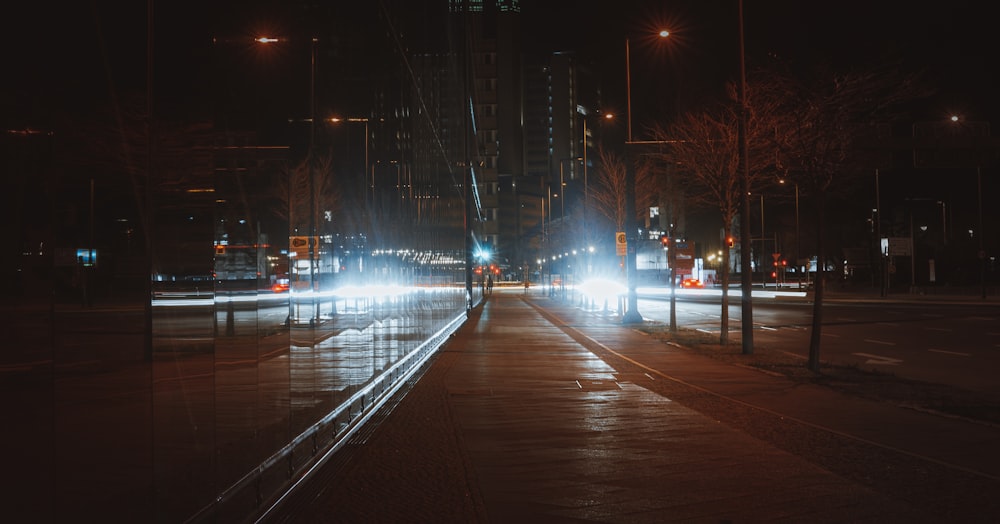 a city street at night with traffic lights