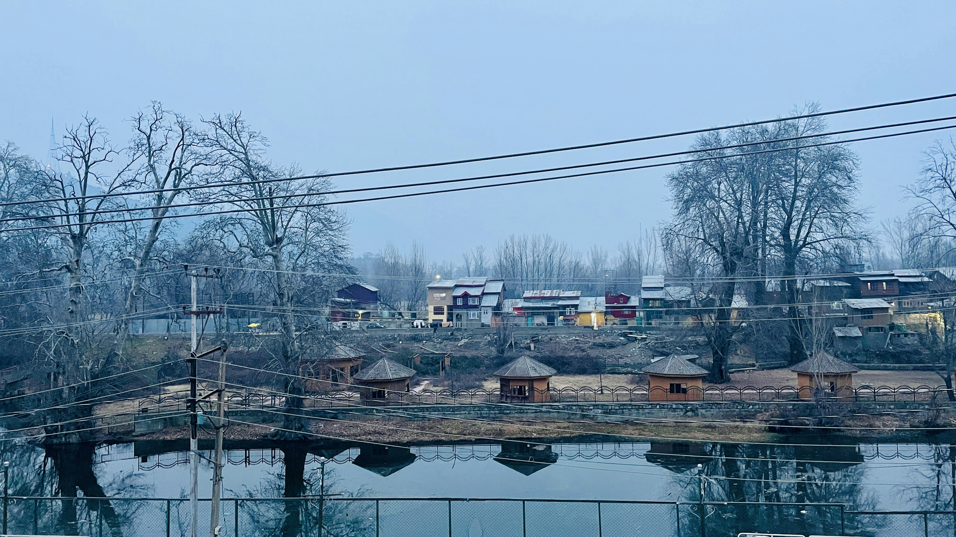 a body of water surrounded by power lines