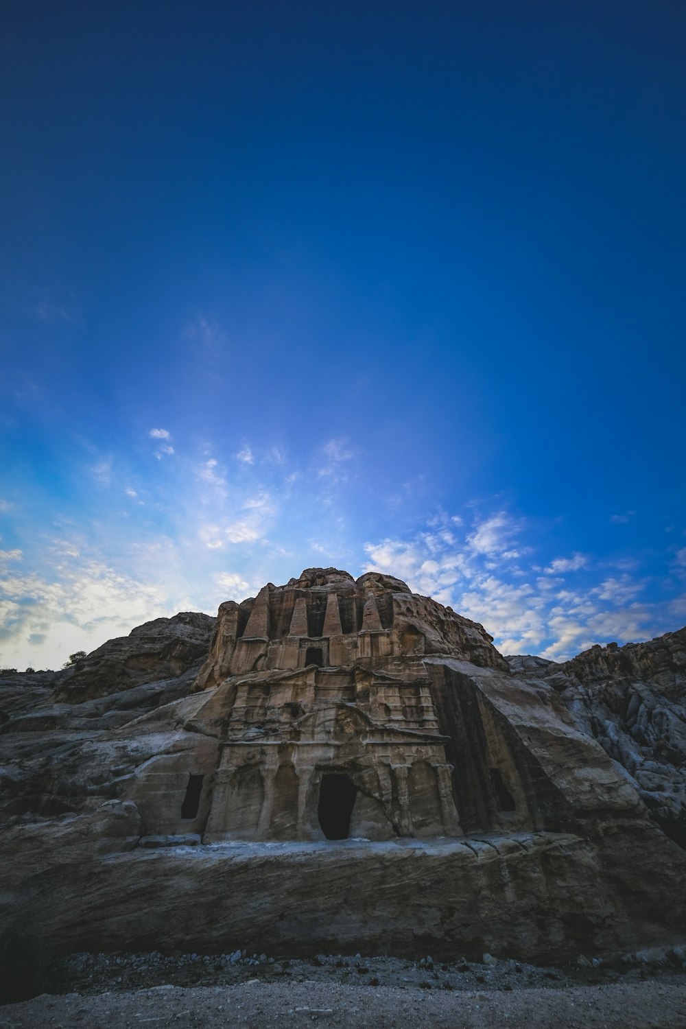 a large rock formation in the middle of a desert