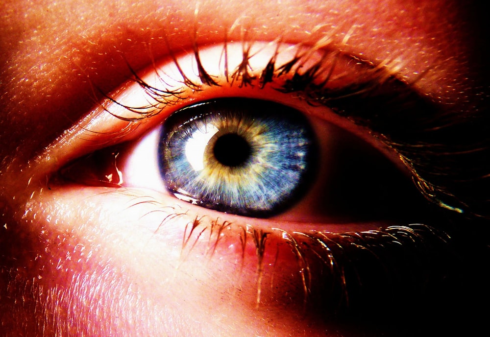 a close up of a person's blue eye