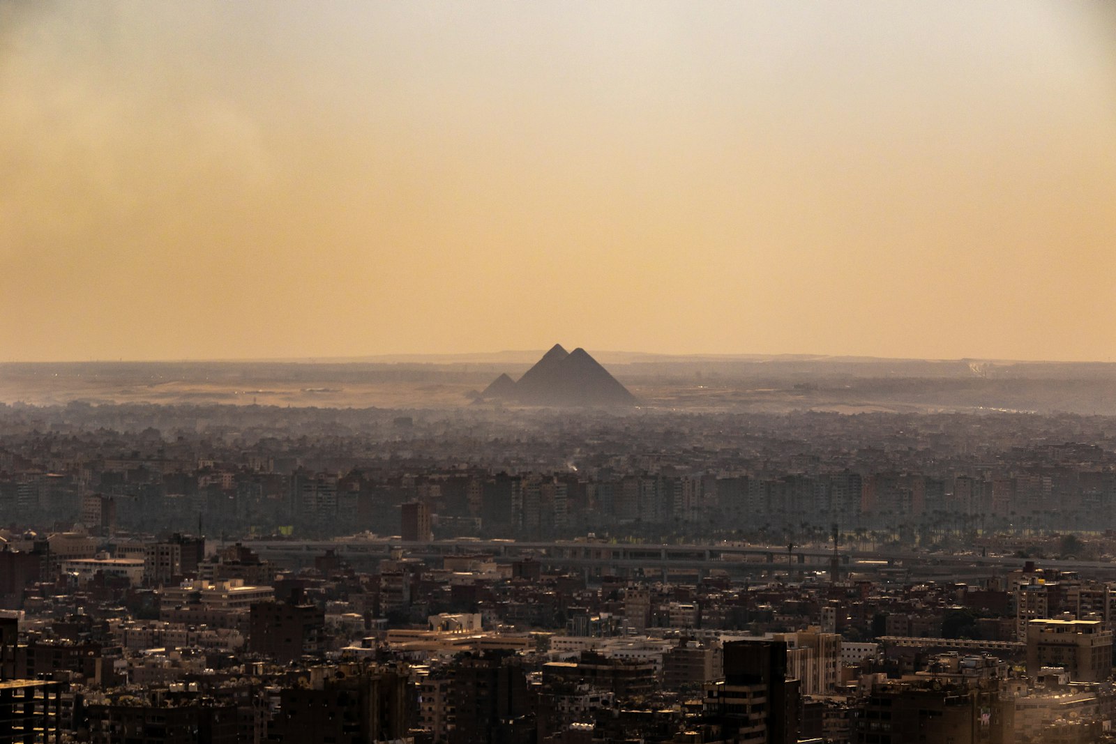 The Cairo skyline with a pyramid visible in the distance