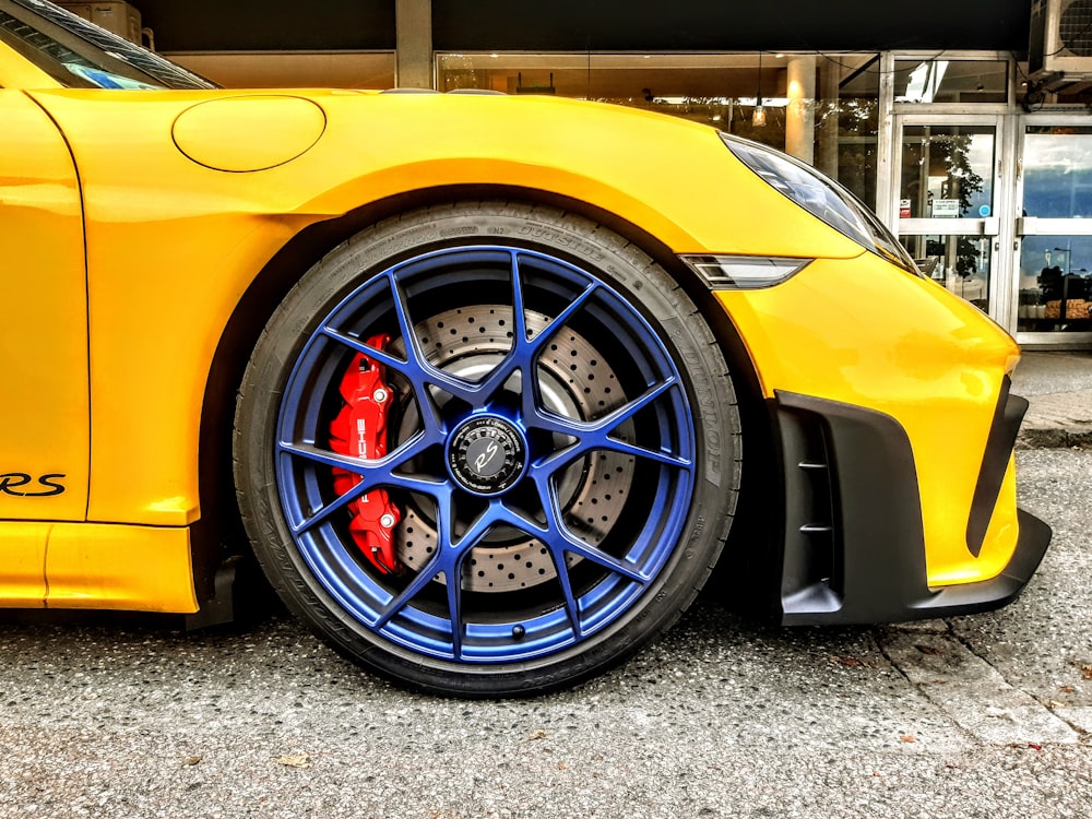 a yellow sports car parked in front of a building