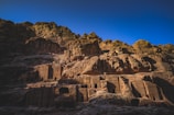 The ancient cliffside carvings at Mount Tai bathed in golden morning light.
