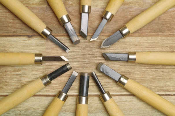 A vibrant display of various chisels and carving tools neatly arranged on a pegboard.