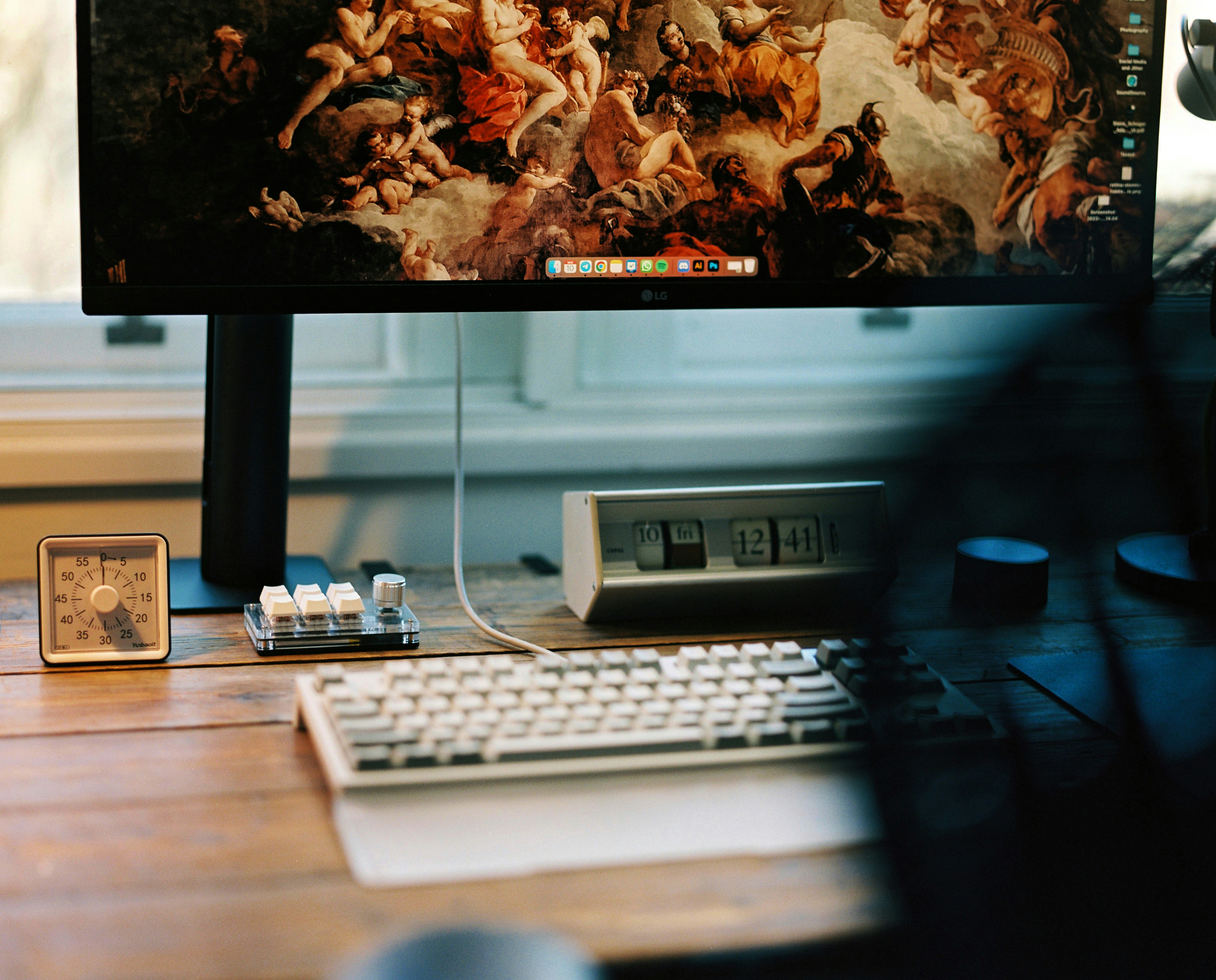 a computer monitor sitting on top of a wooden desk