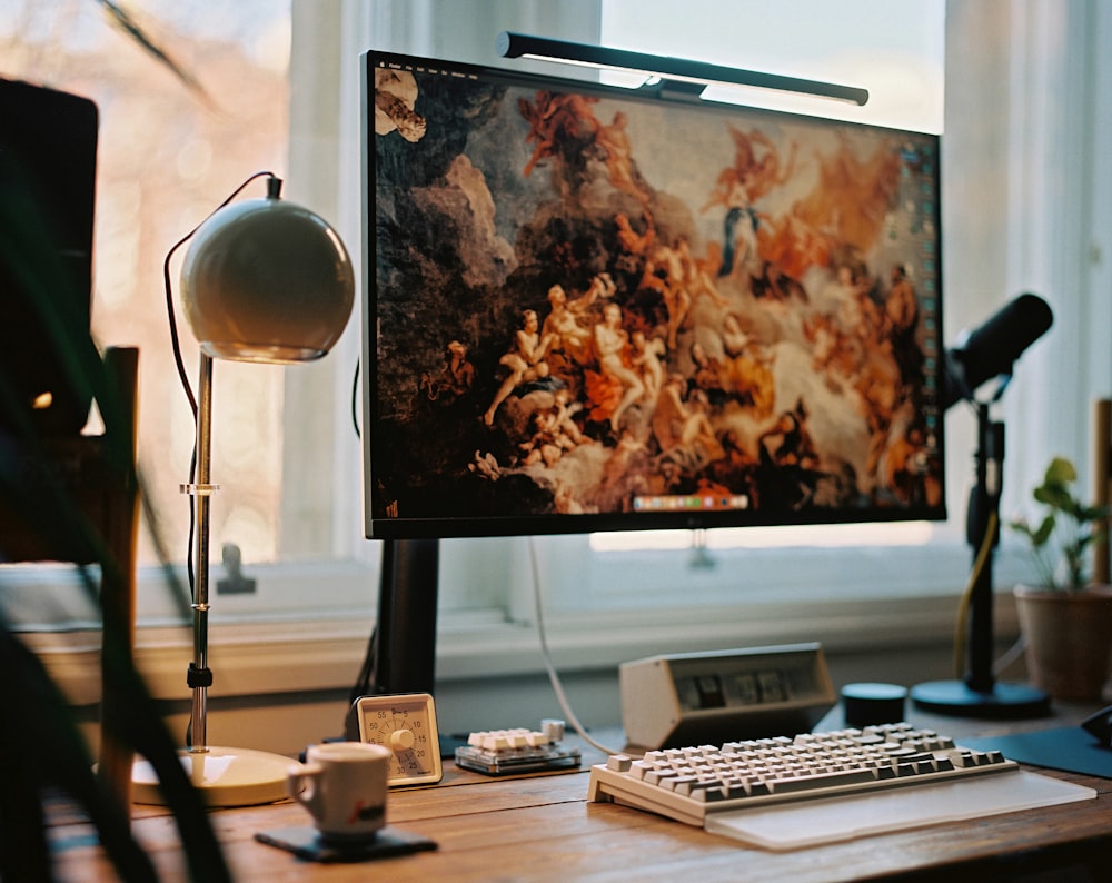 a computer monitor sitting on top of a wooden desk