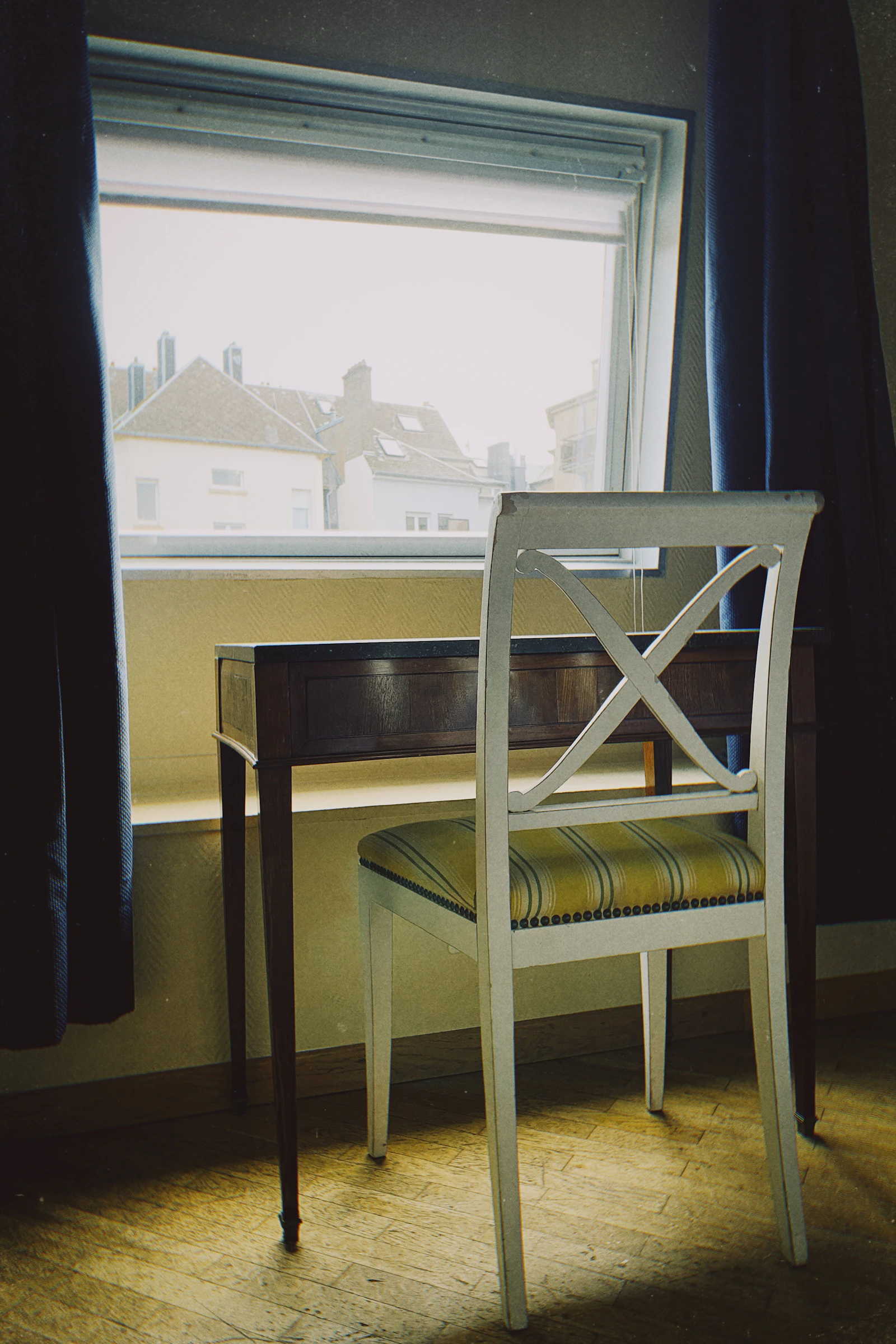Empty chair and desk beside a window, representing a conversation that is no longer being revisited