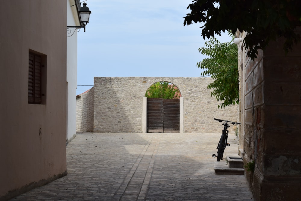 a bike is parked on a cobblestone street