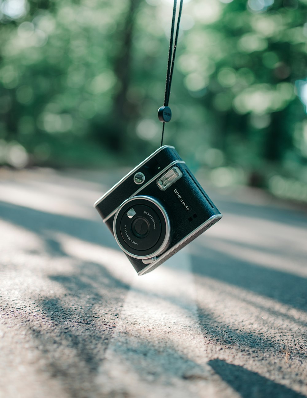 a camera hanging from a cord on a road