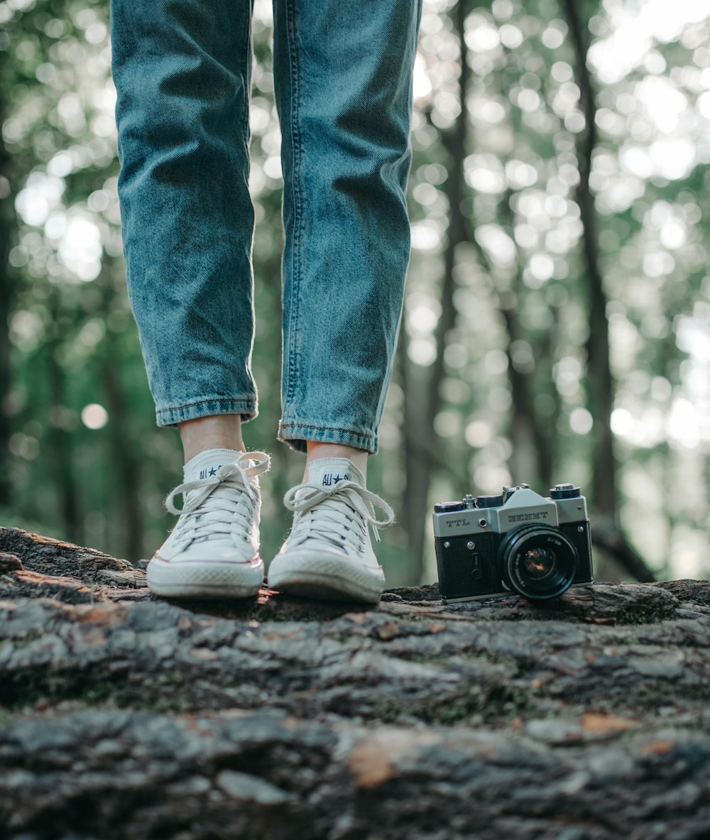 a person standing on top of a tree trunk