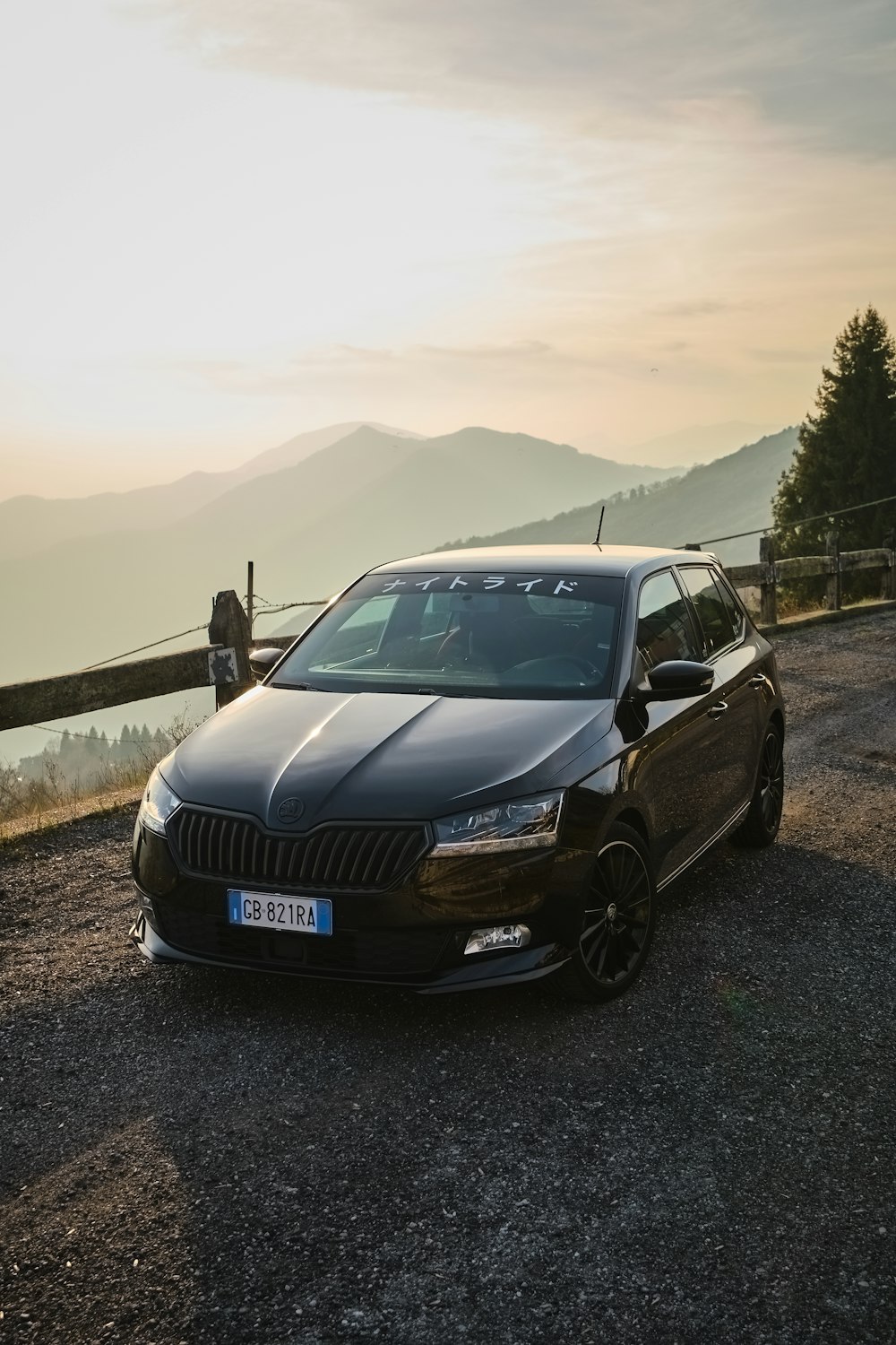 a black car parked on the side of a road