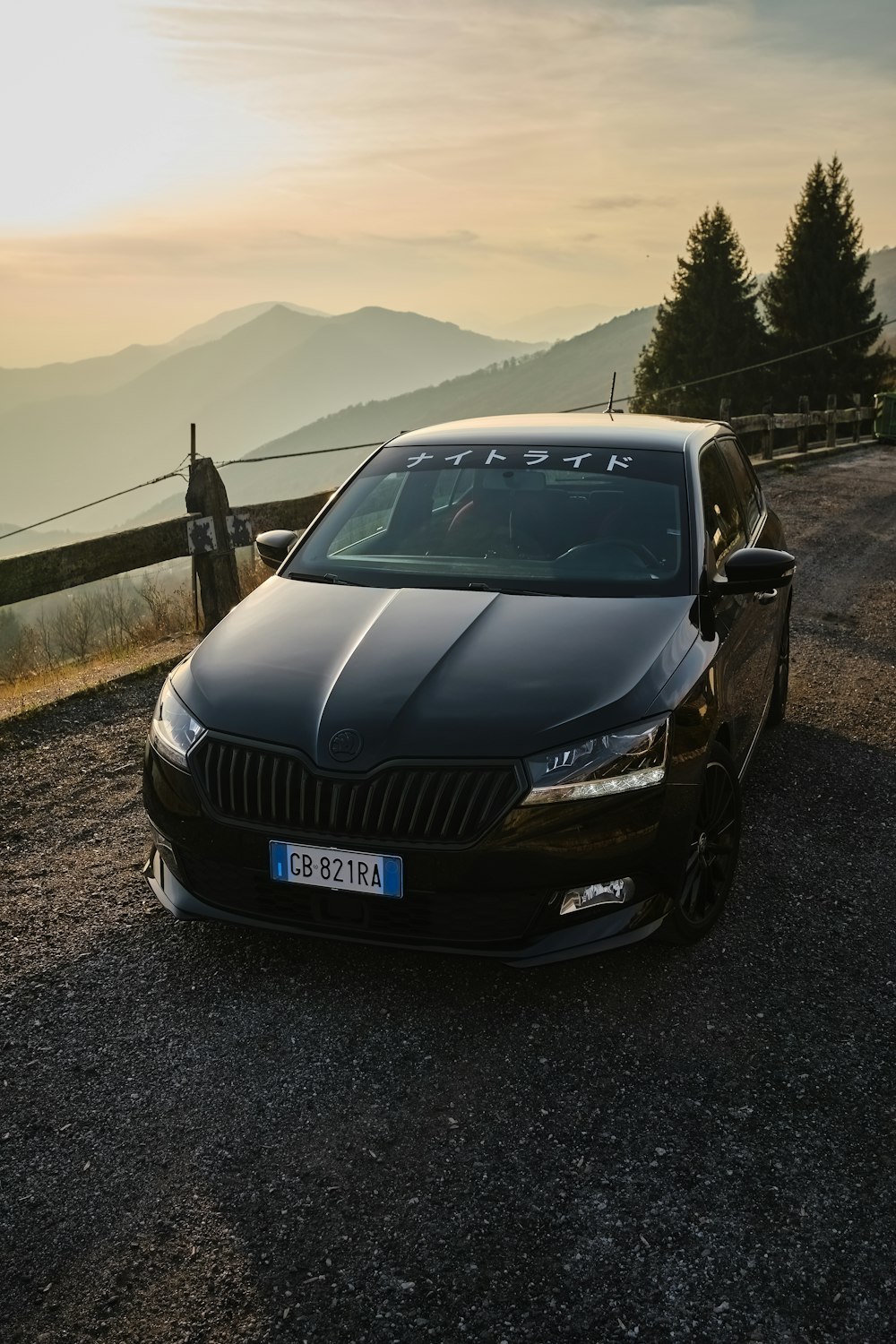 a black car parked on the side of a road