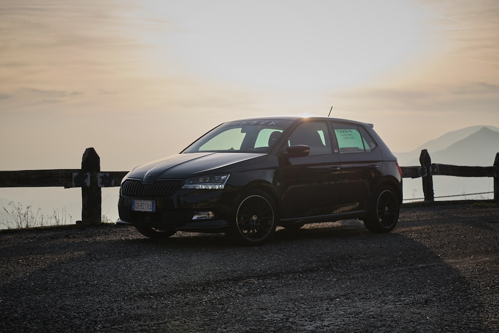 a black car parked on the side of a road