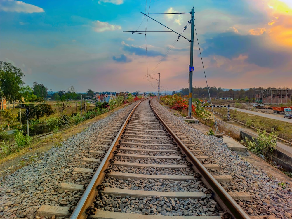 a train track with a sky in the background