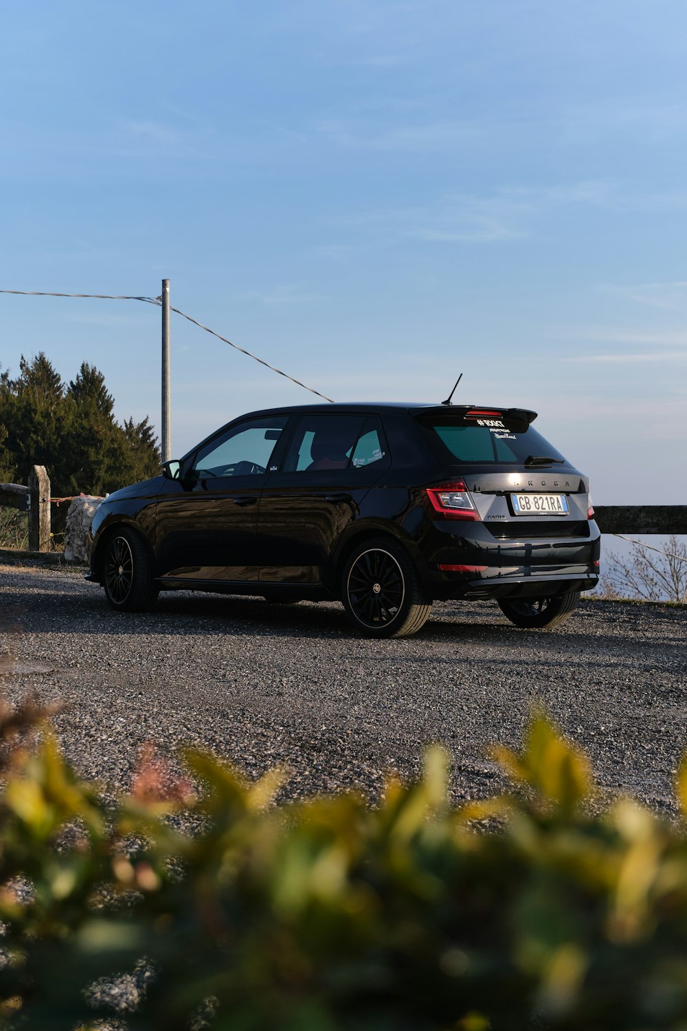 a black car parked on the side of a road