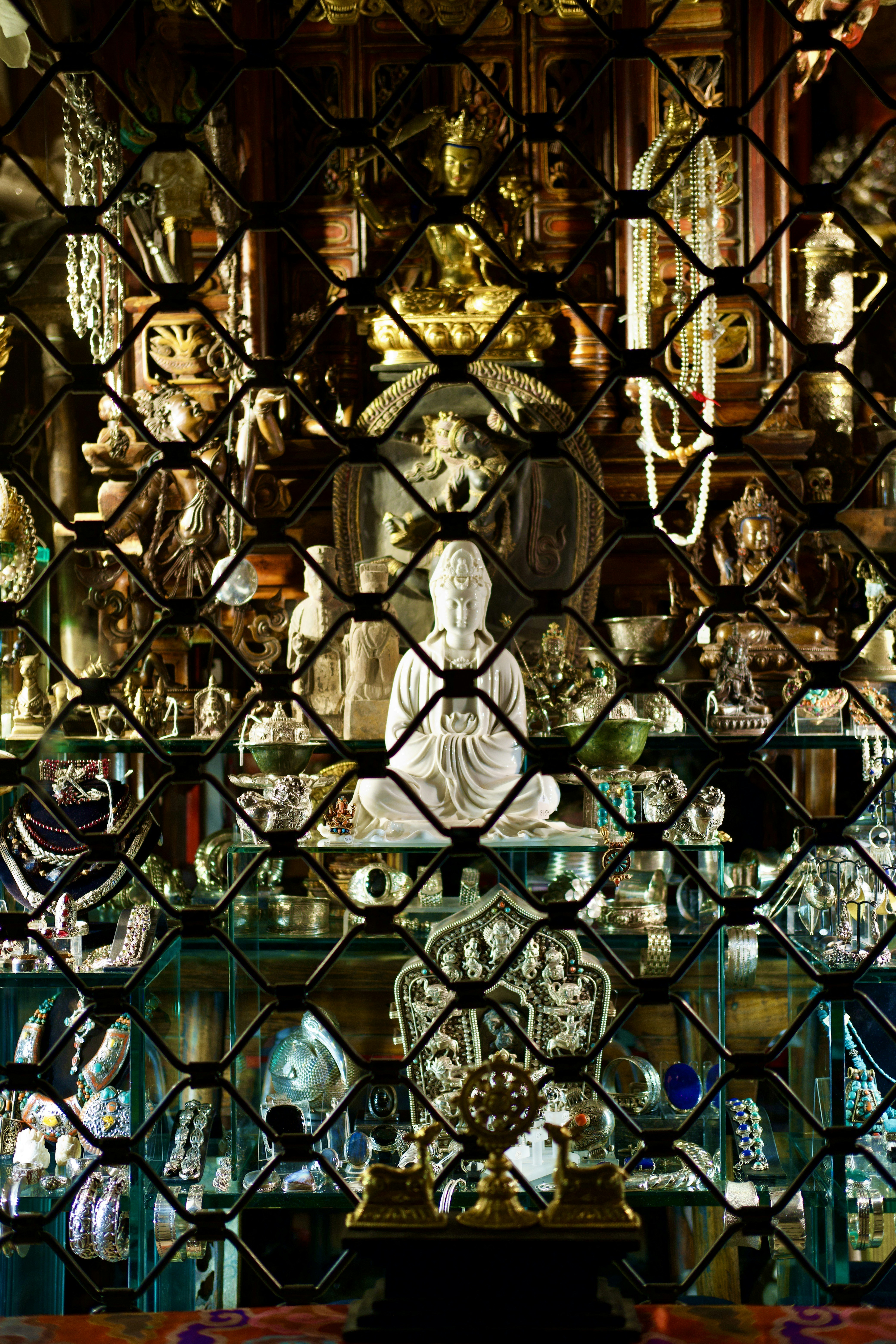 a glass case with a buddha statue behind it