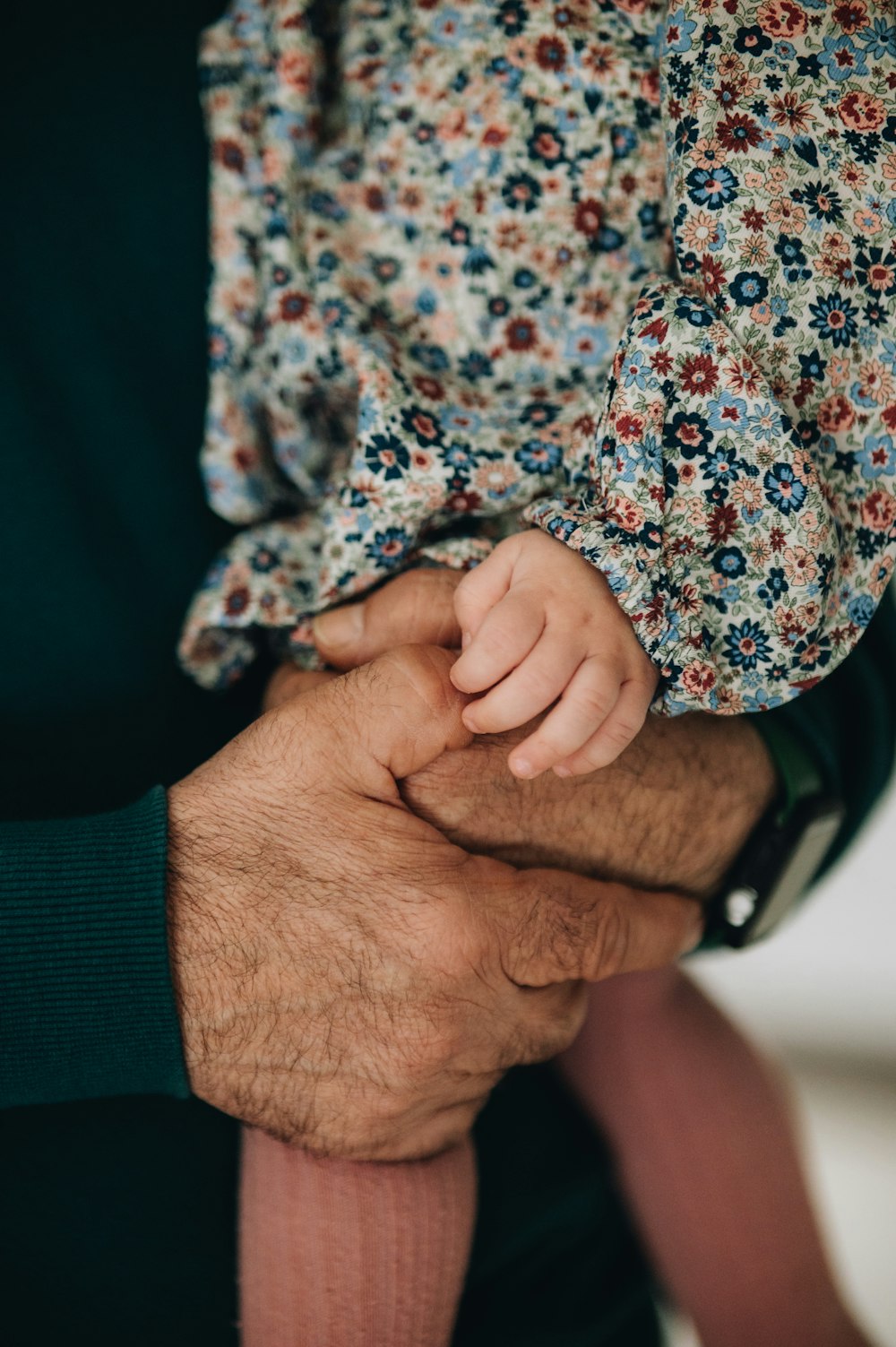 a close up of a person holding a baby